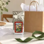 ANASU Armenia coffee bag beside plain gift wrapping and a green ribbon