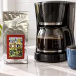 ANASU Armenia ground coffee beside an automatic drip brewer and blue coffee mug