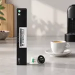 Colombia espresso capsule carton and Original-format capsules beside a demitasse